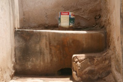 A bucket toilet in a home.