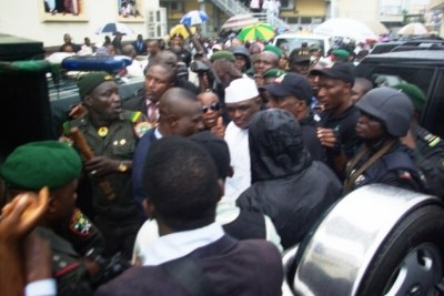 Major Hamza Al-Mustapha arrives at court to face charges of murder.