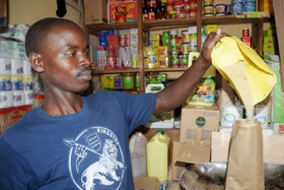 A shop attendant packages sugar.