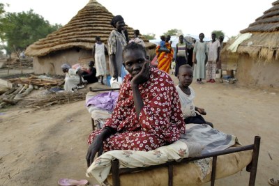 A woman and her daughter seek shelter after fleeing from her home in the village of Abyei.