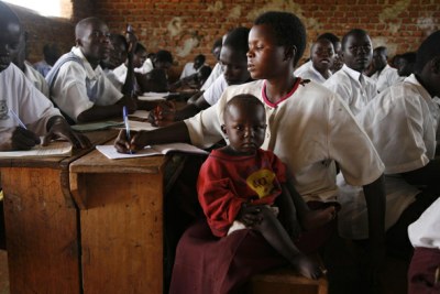 A young woman, a former abductee of a rebel group, returned to school with her son, in Uganda.
