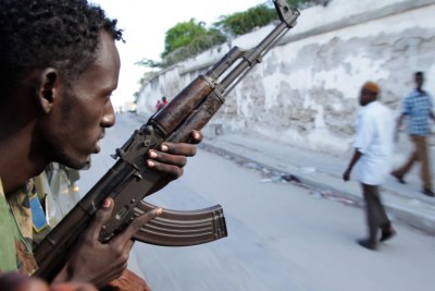 A soldier of the Somali National Army travels through the streets of Mogadishu (file photo).
