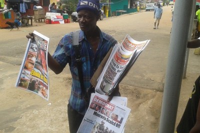 A newspaper vendor sells the local dailies (file photo).