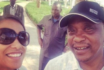 President Uhuru Kenyatta takes a picture while in Abu Dhabi.