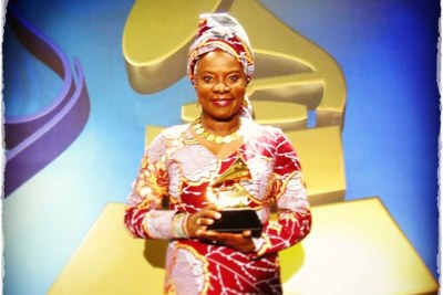 Angelique Kidjo holding her second Grammy.