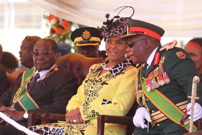 President Robert Mugabe looks on as First Lady Grace Mugabe talks to Commander of the Zimbabwe Defence Forces Constantine Chiwenga (file photo).