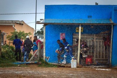 People run away after looting a store owned by immigrants (file photo).