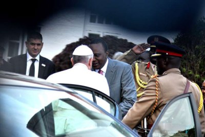Pope Francis and President Uhuru Kenyatta shake hands at State House, Nairobi on November 25, 2015.