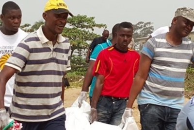 Carrying the dead body of Harry Greaves, former managing director of the Liberian Petroleum Refining Company.