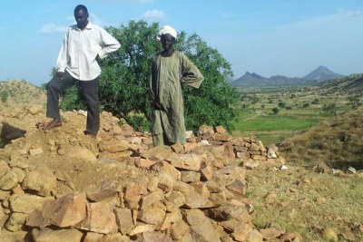 Men stand on a storage hole in Leeba, Marra region of Western Sudan  (file photo).