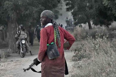 A Boko Haram fighter walks through the town of Banki as militants wage an attack on a nearby military barracks (file photo)..