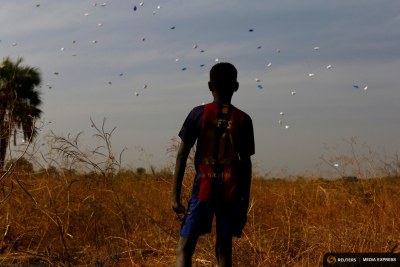 A boy watches sacks of food drop in northern South Sudan (file photo).