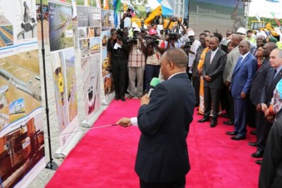 President John Magufuli (in light blue suit) and other government officials get briefing from Rail Assets Holding Company Limited (RAHCO) Acting Managing Director Masanja Kadogosa on the 300-kilometre Dar es Salaam-Morogoro Standard Gauge Railway line after the head of state laid the foundation stone at Pugu Station on the outskirts of Dar es Salaam city.