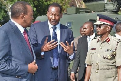 Joseph Nkaissery with President Uhuru Kenyatta, Principal Secretary Karanja Kibicho and Inspector General Joseph Boinnet, when the Head of State commissioned the Armoured Personnel Carriers.