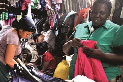Jessica Kiyingi, a vendor at Kampala’s Owino market, selling second-hand clothes.