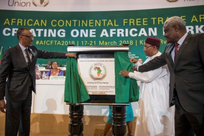 African Union chair and Rwandan President Paul Kagame, President Mahamadou Issoufou of Niger, and the chair of the African Union Commission Moussa Faki Mahamat unveil a plaque marking the launch of the African Continental Free Trade Area at the Kigali Convention Centre on March 21, 2018.