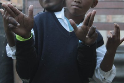 Calvin and Mikey (not their real names), seen here doing a gang salute, want to exit the gangs.