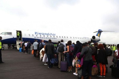 Passengers board a RwandAir plane.