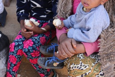 A group of Eritrean men, women and children who have just been dropped off dusty and tired at the entry point in the small town of Adinbried, about 50km southeast of Badme, having crossed the border during the preceding night.