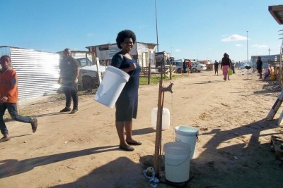 A resident draws water from a community tap (file photo).