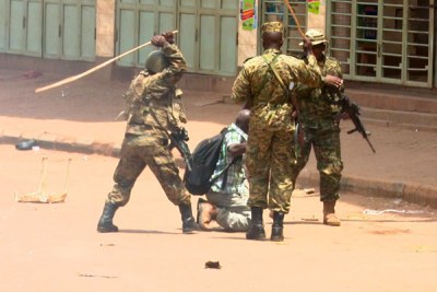 Ugandan soldiers beating up Reuters photojournalist James Akena as he covered the protests over the detention of several Opposition MPs in Kampala (file photo).