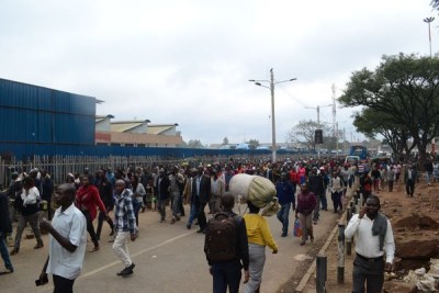 Commuters walk to work in the CBD after being dropped off at the Railways terminus on December 3, 2018.
