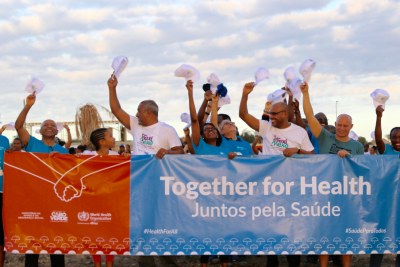 World Health Organization Regional Director for Africa, Dr Matshidiso Moeti, and H.E. Dr Fernando Elísio Freire, Minister of State, Parliamentary Affairs, President of the Council of Ministers and Minister of Sports joined hundreds of people who held hands and stood side by side in an umbrella shape on Quebra Canela beach in Praia to show their solidarity for universal health coverage.