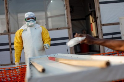 MSF medical staff in protective gear on a shift in the high-risk zone to check people with suspected cases of Ebola. (file photo).