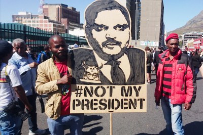 A protest placard depicting Atul Gupta carried by two EFF members at a Zuma Must Fall protest in Cape Town (file photo).