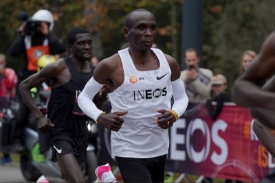 Eliud Kipchoge (in white singlet) runs flanked by pacesetters during the INEOS 1:59 Challenge at Prater Park in Vienna, Austria on October 12, 2019.