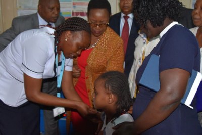 Health Cabinet Secretary Sicily Kariuki witnesses the vaccination a 10 year old girl with HPV vaccine at Othaya Health Centre in Nyeri County (file photo).