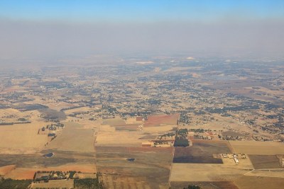 A plane flies above smog above Kempton Park in Gauteng, South Africa.
