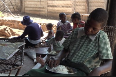 Orphans in Harare's Kambuzuma township eat a meal provided by the charity Faith Community Support.