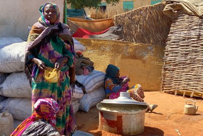 Internally displaced families gather at a temporary gathering point in El Geneina town.
