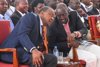 President Uhuru Kenyatta (left) chats with his deputy, William Ruto (file photo).