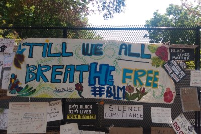 Posters and banners affixed to a security fence erected around the White House in June 2020.