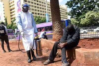 An official from the Nairobi Health Department disinfects a street (file photo).