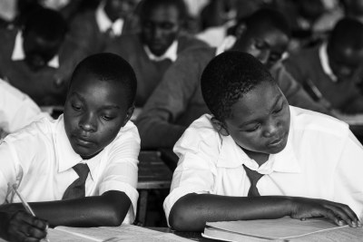 Students taking notes in class as part of a Mastercard Foundation partnership with STiR Education.