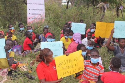 Women from Mokutani in Tiaty East Sub-county hold placards to relay anti-GBV messages as part of a celebration to mark 16 Days of Activism against violence (file photo).