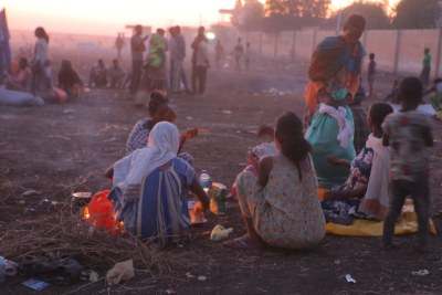 Ethiopian refugees fleeing clashes in the country's northern Tigray region, rest and cook meals near UNHCR's Hamdayet reception centre after crossing into Sudan.