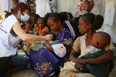 An MSF nurse checks screens a child for malnutrition at a mobile clinic in Adiftaw in the Tigray region.