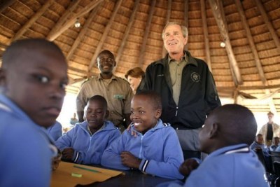 President George W. Bush talks to students attending nature classes at the Mokolodi Nature Reserve near Gaborone, Botswana Thursday, July 10, 2003.
