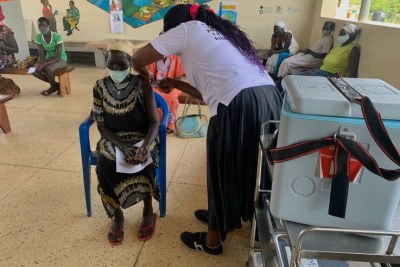 Mary Nyoka, 65, of South Sudan gets the AstraZeneca Covid-19 vaccine at Swinga Health Centre 3 in Bidibidi. settlement, Yumbe district, northern Uganda.