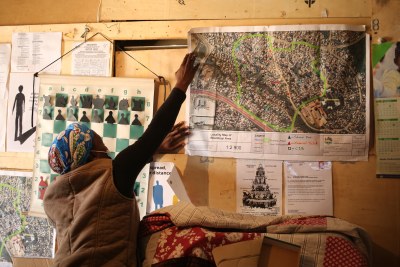 Blessing Nyoni pins a map to the wall that shows the informal settlement of Bhambayi near Phoenix. About 70 families live in this area.