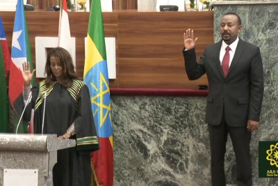 Ashenafi Meaza, right, swearing in Abiy Ahmed as Prime Minister of Ethiopia. Photo: HoPR.