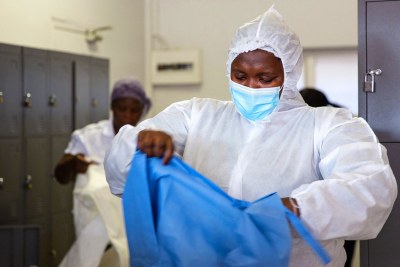 A nurse at the special Covid-19 Field Hospital in Nasrec, Johannesburg, South Africa, puts on her PPE (file photo)