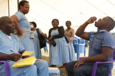 Malawian journalist Kenneth Jali takes the cholera vaccine during the launch of the vaccination campaign in Blantyre, May 23, 2022.