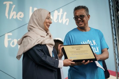 Dr. Hanan Mohamed Al Kuwari, Qatar Minister of Public Health, receiving the 2022 Health Champion Award for her leadership on the #Sport4Health initiative from Dr. Tedros Adhanom Ghebreyesus,  Director-General of the World Health Organization at the Walk The Talk event in Geneva in May.