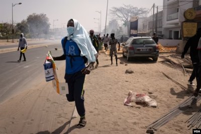 Protesters run from tear gas in Dakar, Senegal, March 30, 2023.