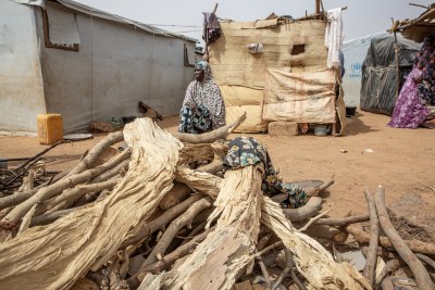 Mariam, a mother of five, is sitting outside the small shelter her family built after they fled to Kongoussi, in northern Burkina Faso, after armed groups made life in their village unbearable.   
